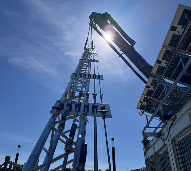 A crane installs the exhaust gas and ventilation stack at the H<sub>2</sub>-in-the-Loop facility.